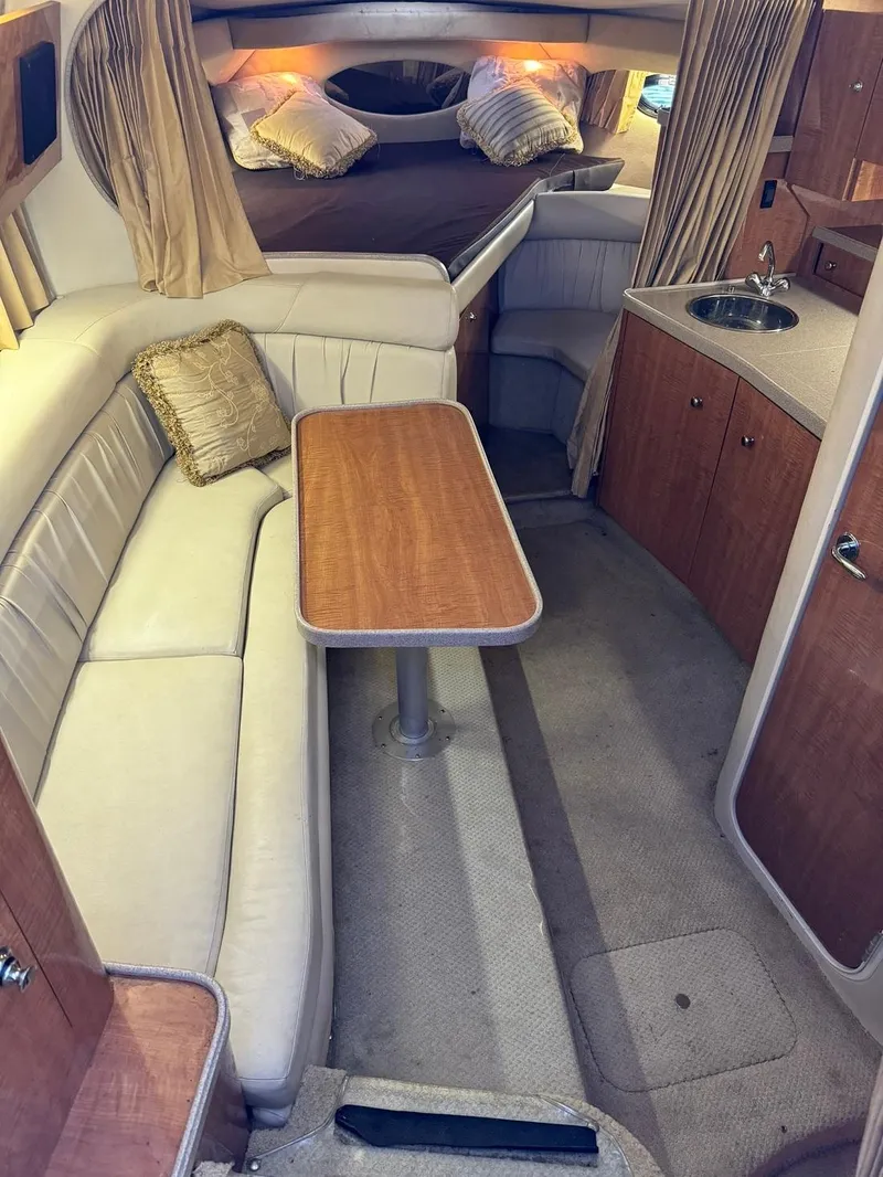 Slide: The Image of 2004 Regal 3260 Commodore yacht interior with seating, table, and kitchenette. - 26