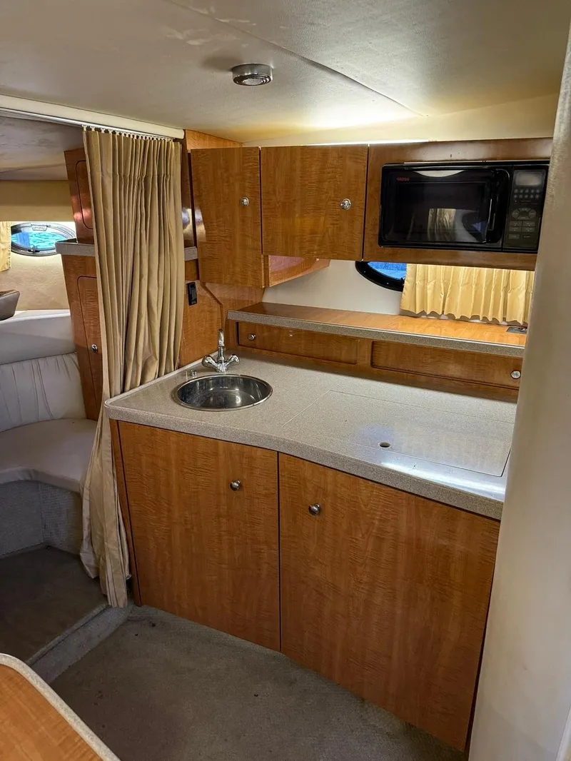 Slide: The Image of 2004 Regal 3260 Commodore boat interior with kitchenette and microwave. - 28