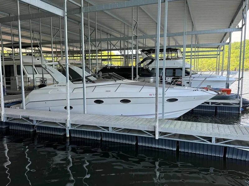 Slide: The Image of 2004 Regal 3260 Commodore yacht docked in a covered marina. - 3