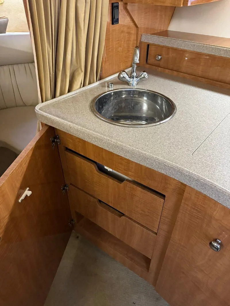 Slide: The Image of 2004 Regal 3260 Commodore boat interior kitchen sink and storage drawers - 31