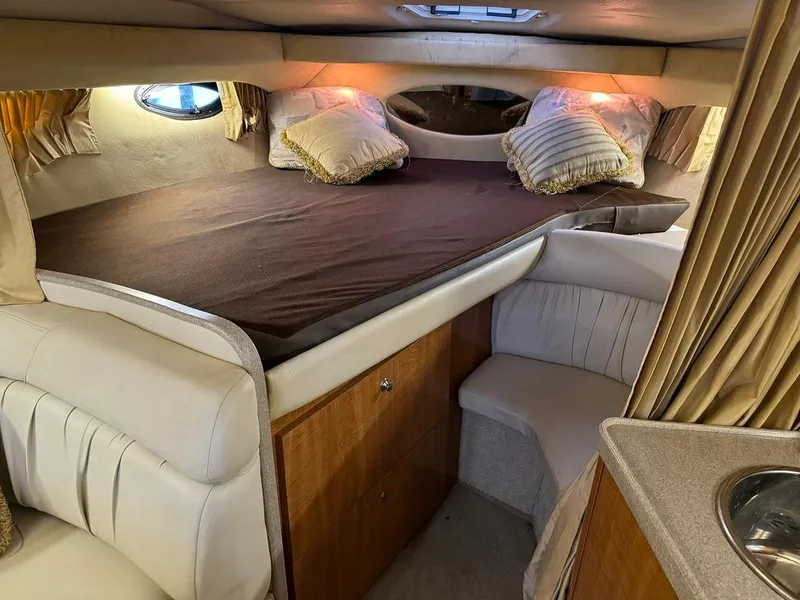 Slide: The Image of 2004 Regal 3260 Commodore cabin interior with bed and seating area. - 32