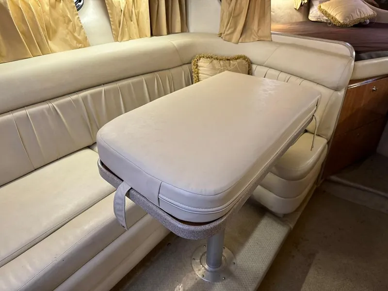 Slide: The Image of 2004 Regal 3260 Commodore interior with beige leather seating and table. - 37