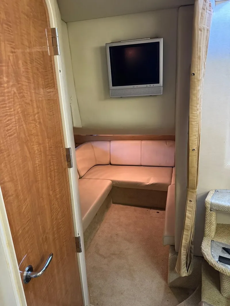 Slide: The Image of 2004 Regal 3260 Commodore cabin with TV and seating area. - 38