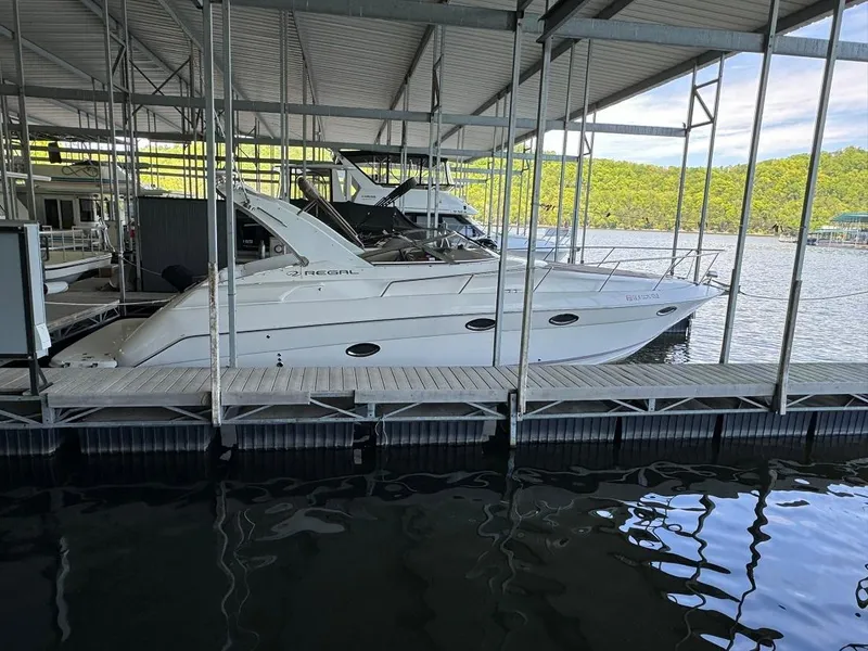 Slide: The Image of 2004 Regal 3260 Commodore yacht docked in a marina. - 4