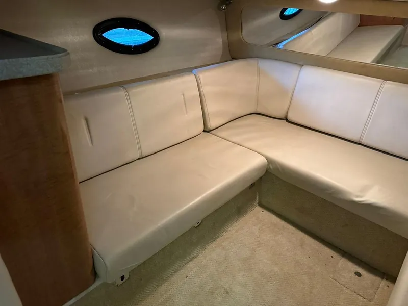 Slide: The Image of 2004 Regal 3260 Commodore interior seating area with beige upholstery. - 40