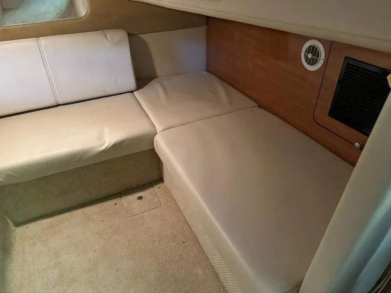 Slide: The Image of 2004 Regal 3260 Commodore cabin interior with beige seating and wood paneling. - 41