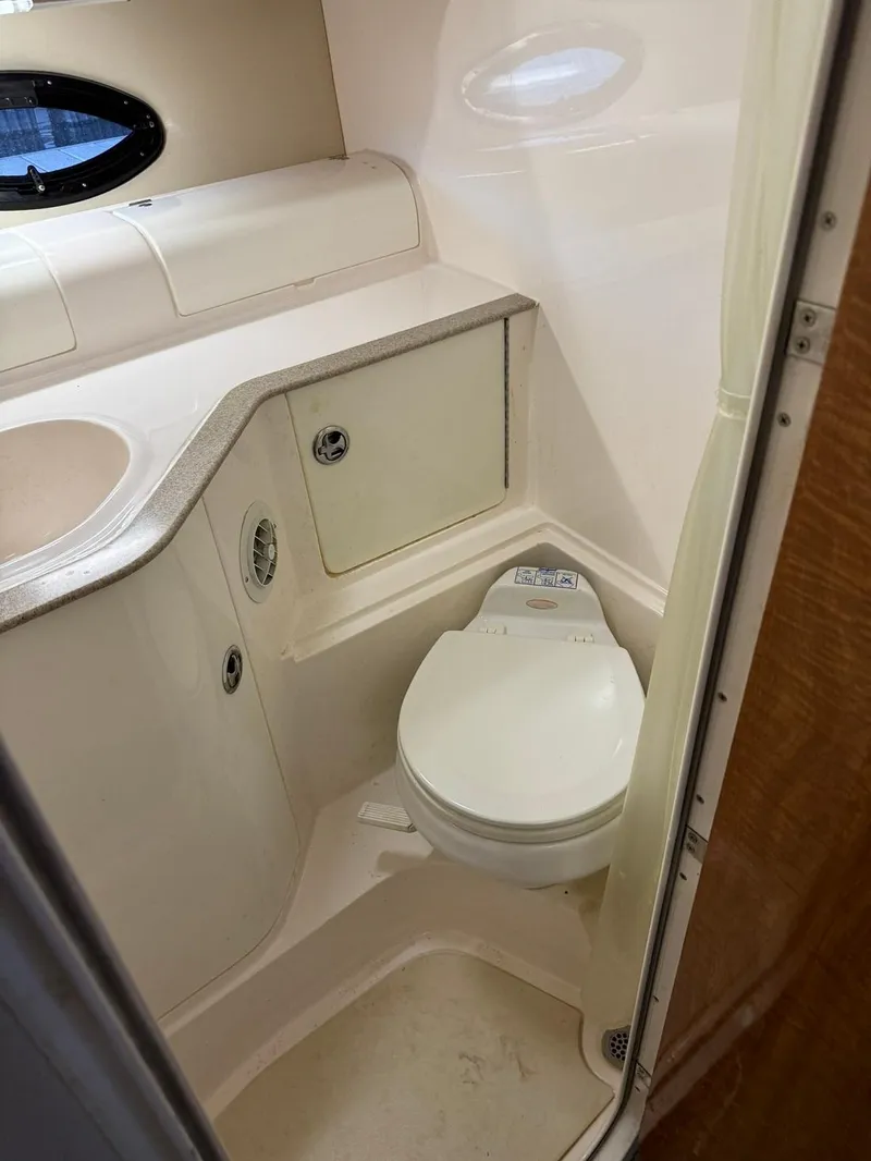 Slide: The Image of 2004 Regal 3260 Commodore boat bathroom with toilet and sink. - 44
