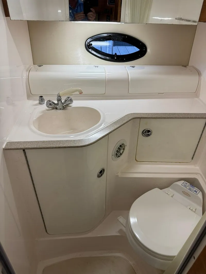 Slide: The Image of 2004 Regal 3260 Commodore boat bathroom with sink, toilet, and storage. - 45