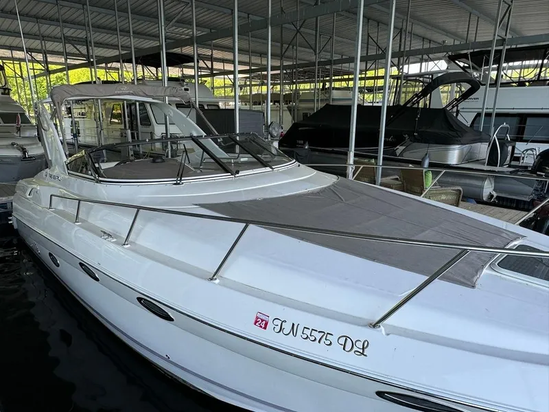 Slide: The Image of 2004 Regal 3260 Commodore boat docked in a marina. - 5