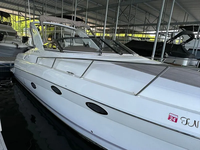 Slide: The Image of 2004 Regal 3260 Commodore boat docked in a marina. - 6