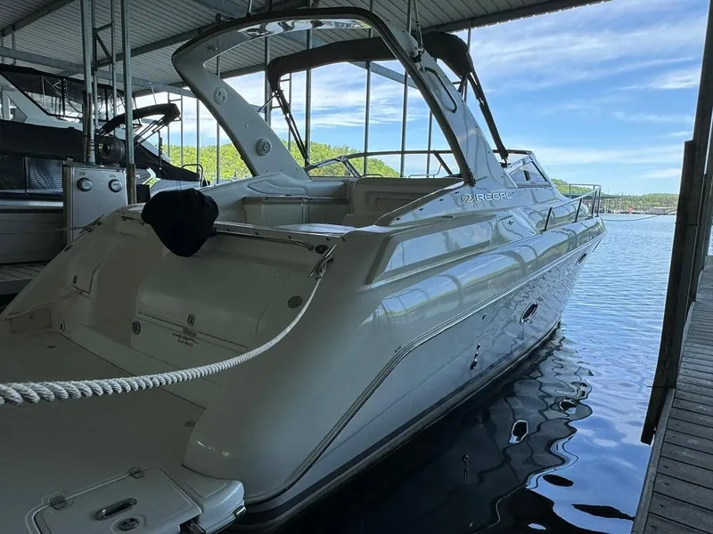 Slide: The Image of 2004 Regal 3260 Commodore boat docked in a marina. - 7