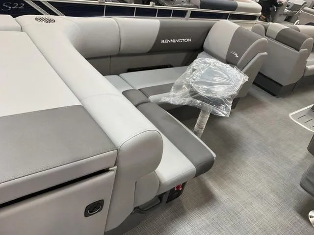 Slide: The Image of 2024 Bennington 22 SVL boat interior with captain's chair and bubble wrap. - 11