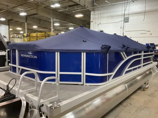 Slide: The Image of 2024 Bennington 22 SVL boat interior with gray seating and a cardboard box. - 7