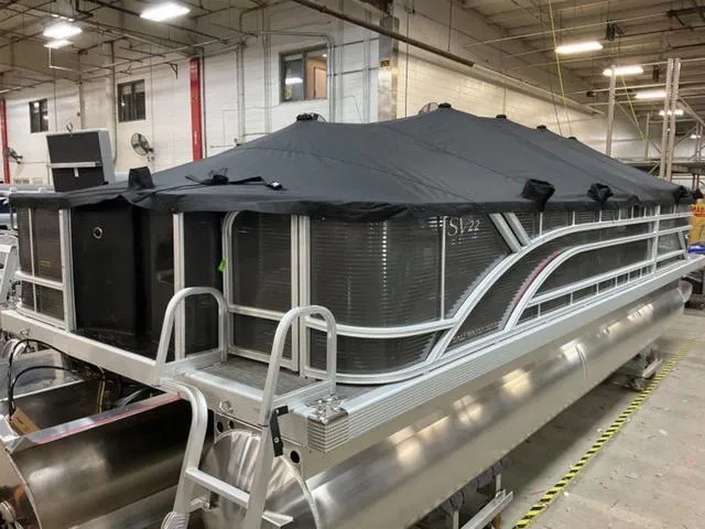 Slide: The Image of 2024 Bennington 22 SVS pontoon boat with cover in a warehouse. - 5