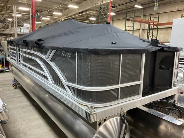Slide: The Image of 2024 Bennington 22 SVS pontoon boat in a factory setting. - 6