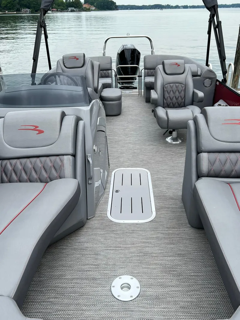 Slide: The Image of 2022 Bennington 24 LXFB pontoon boat with luxurious seating and spacious deck. - 12