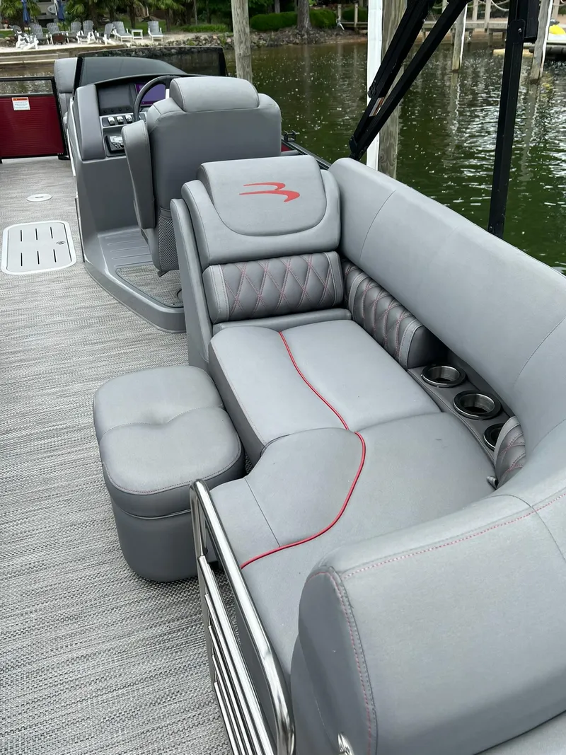 Slide: The Image of 2022 Bennington 24 LXFB pontoon boat with luxurious gray seating and cup holders. - 17