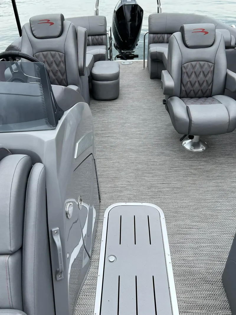 Slide: The Image of 2022 Bennington 24 LXFB pontoon boat interior with luxurious gray seating. - 24