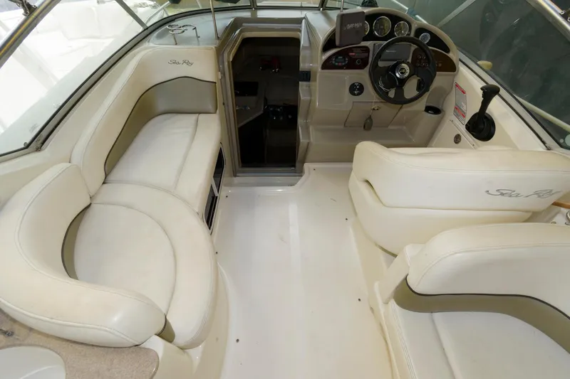 Slide: The Image of 2005 Sea Ray 260 Sundancer boat interior with helm and seating area. - 4