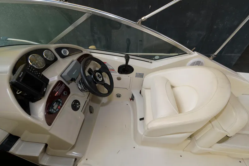 Slide: The Image of 2005 Sea Ray 260 Sundancer helm with steering wheel and captain's chair. - 5