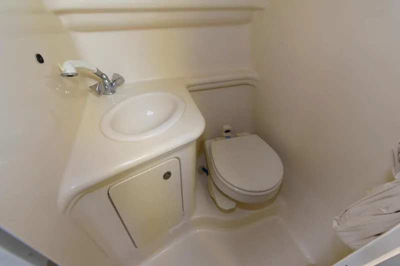 Slide: The Image of Compact bathroom in 2005 Sea Ray 260 Sundancer boat with sink and toilet. - 9