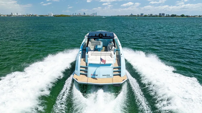 Slide: The Image of 2022 Vanquish Yachts VQ58 cruising on open water, rear view. - 18