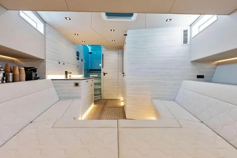 Slide: The Image of Interior of 2022 Vanquish Yachts VQ58, featuring modern white seating and sleek design. - 38