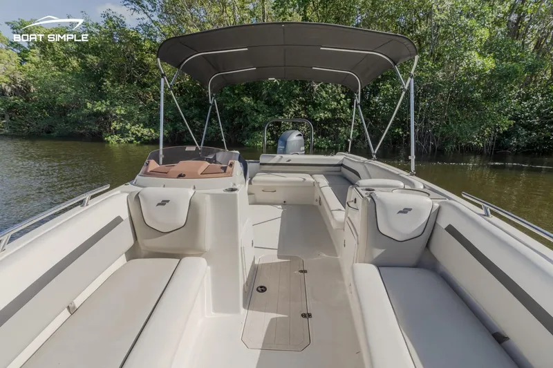 Slide: The Image of 2023 Starcraft SVX 211 OB boat interior with canopy on a calm river. - 9