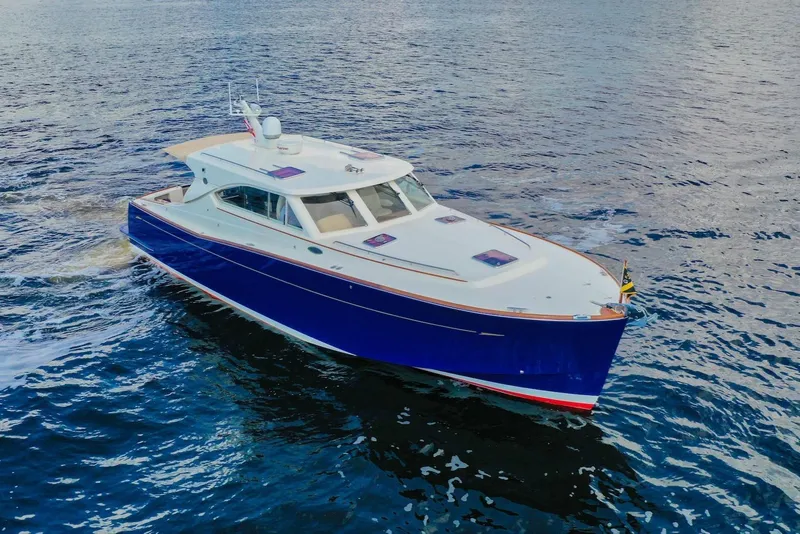 Slide: The Image of 2007 Oyster LD43 yacht cruising on open water, featuring sleek blue and white design. - 10