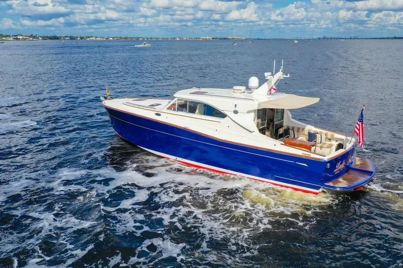 Slide: The Image of 2007 Oyster LD43 yacht cruising on open water under a partly cloudy sky. - 11