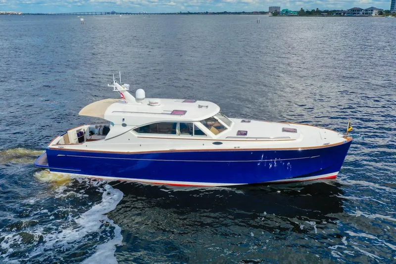 Slide: The Image of 2007 Oyster LD43 yacht cruising on open water, featuring a sleek blue and white design. - 12