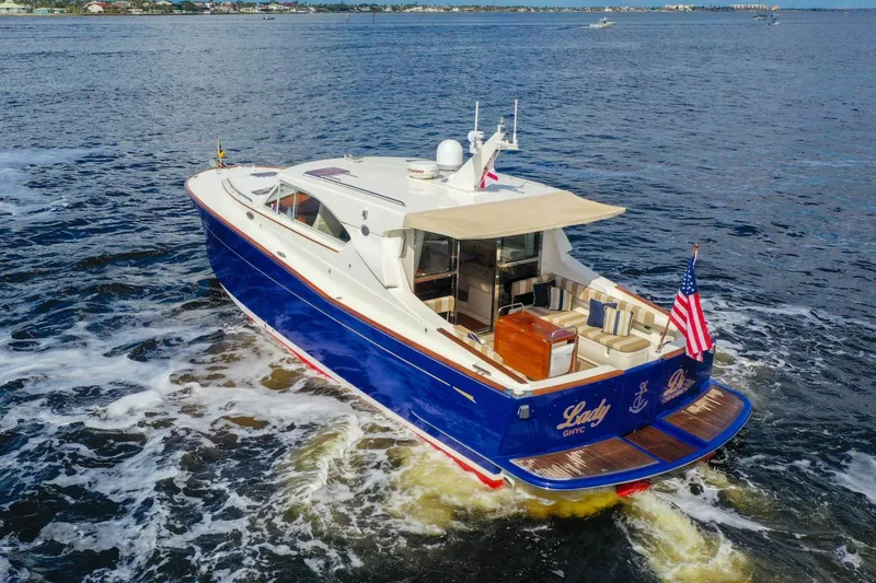 Slide: The Image of 2007 Oyster LD43 yacht cruising on open water with American flag. - 13