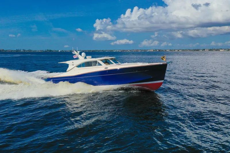 Slide: The Image of 2007 Oyster LD43 yacht cruising on open water under a partly cloudy sky. - 2