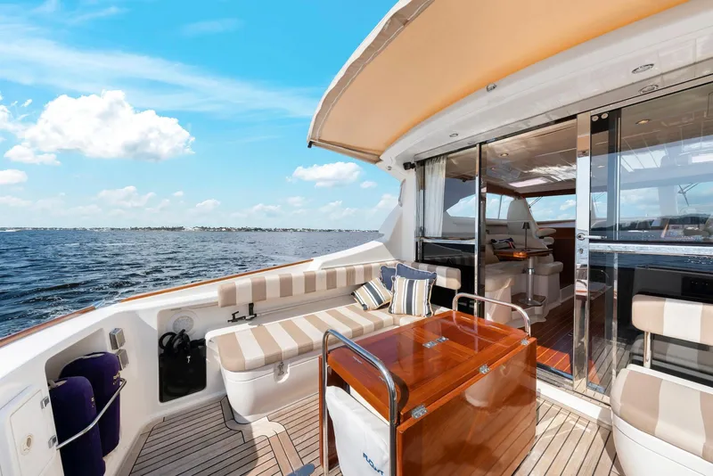 Slide: The Image of 2007 Oyster LD43 yacht deck with seating, table, and ocean view. - 20