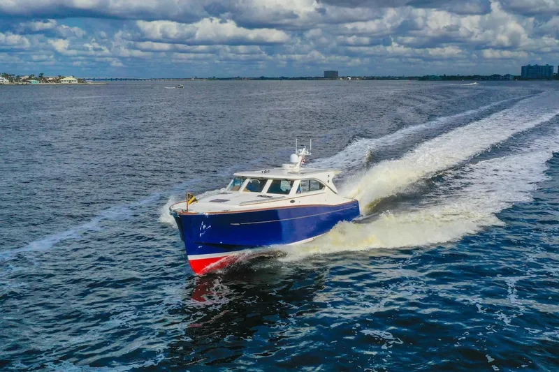 Slide: The Image of 2007 Oyster LD43 yacht cruising on open water under a cloudy sky. - 3