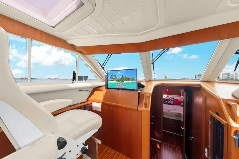 Slide: The Image of Interior of 2007 Oyster LD43 yacht with helm, seating, and navigation screen. - 39