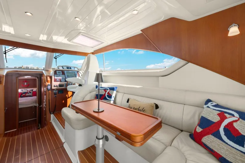 Slide: The Image of Luxurious interior of 2007 Oyster LD43 yacht with plush seating and elegant wood finishes. - 41