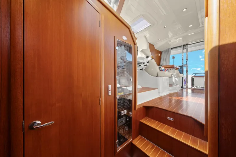 Slide: The Image of Interior of 2007 Oyster LD43 yacht with wooden finishes and steps leading to deck. - 46