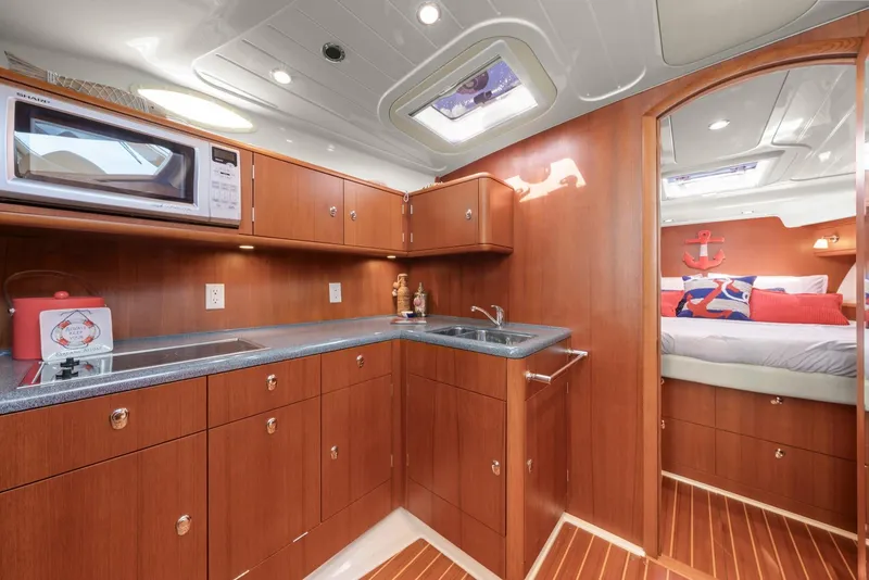 Slide: The Image of Luxurious 2007 Oyster LD43 yacht interior with modern kitchen and cozy bedroom. - 47