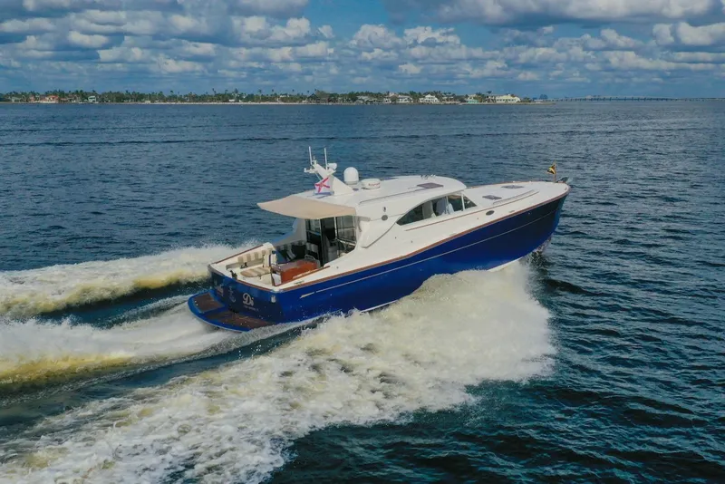 Slide: The Image of 2007 Oyster LD43 yacht cruising on open water under a partly cloudy sky. - 5