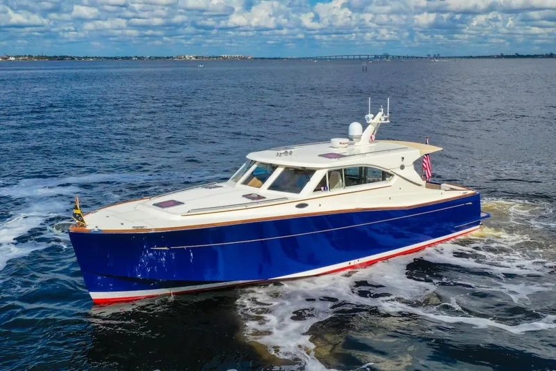 Slide: The Image of 2007 Oyster LD43 yacht cruising on open water under a partly cloudy sky. - 9