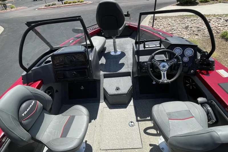 Slide: The Image of 2024 Tracker Targa V-19 Combo boat interior with steering wheel and seating. - 2
