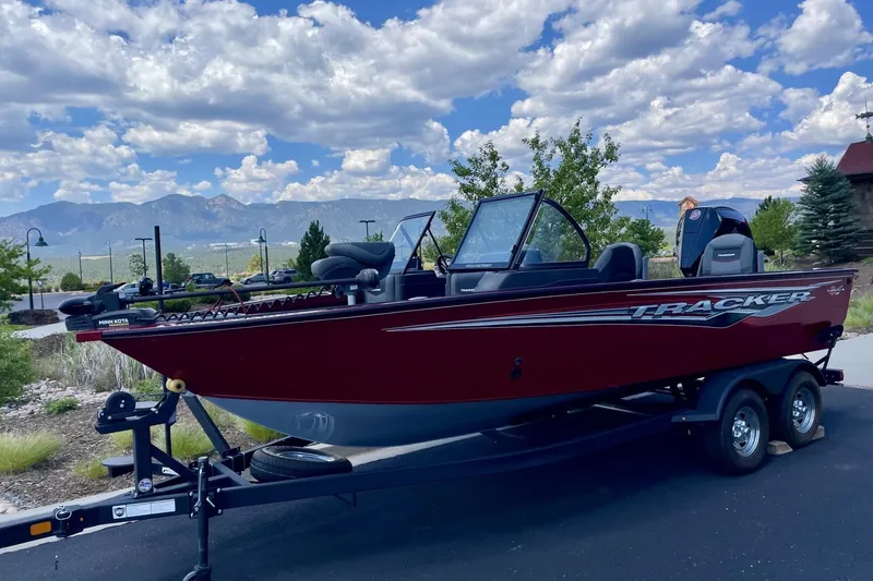 The Image of 2024 Tracker Targa V-19 Combo boat on trailer, scenic mountain backdrop. - 0