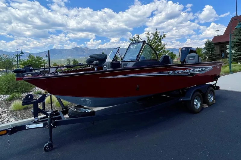 Slide: The Image of 2024 Tracker Targa V-19 Combo boat on trailer, parked outdoors under a cloudy sky. - 3