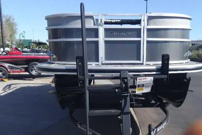 Slide: The Image of 2024 Ranger Reata 220C pontoon boat on a trailer, displayed outdoors. - 3