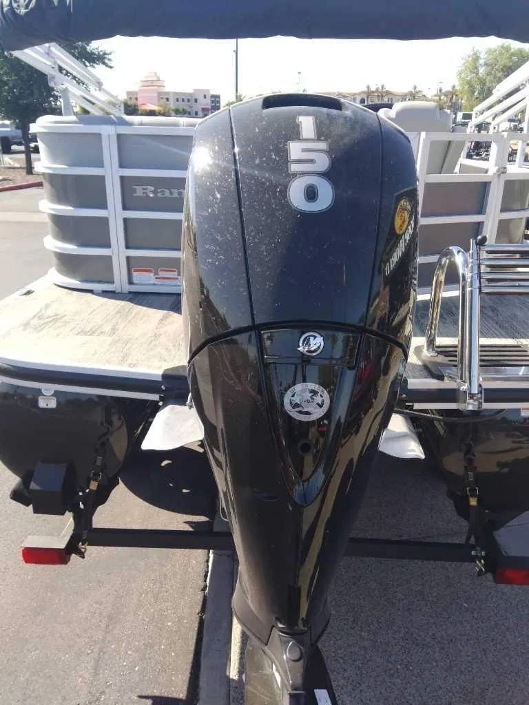 Slide: The Image of 2024 Ranger Reata 220C pontoon boat with a 150 horsepower outboard motor. - 4