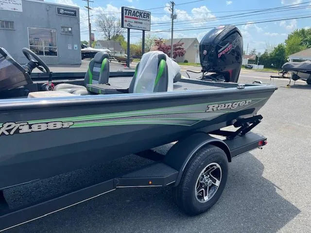 Slide: The Image of 2024 Ranger RT188P fishing boat with trailer, displayed outdoors. - 2
