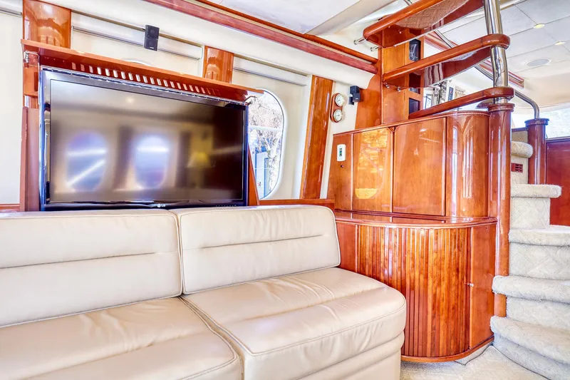 Slide: The Image of Luxurious interior of 2001 Viking Sport Cruisers Motoryacht with leather sofa and TV. - 11