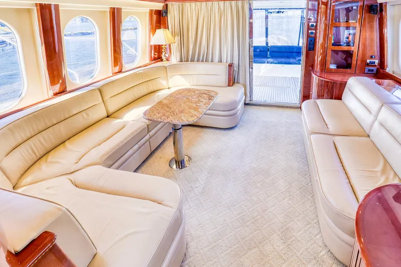 Slide: The Image of Luxurious 2001 Viking Sport Cruisers Motoryacht interior with elegant seating and panoramic windows. - 12