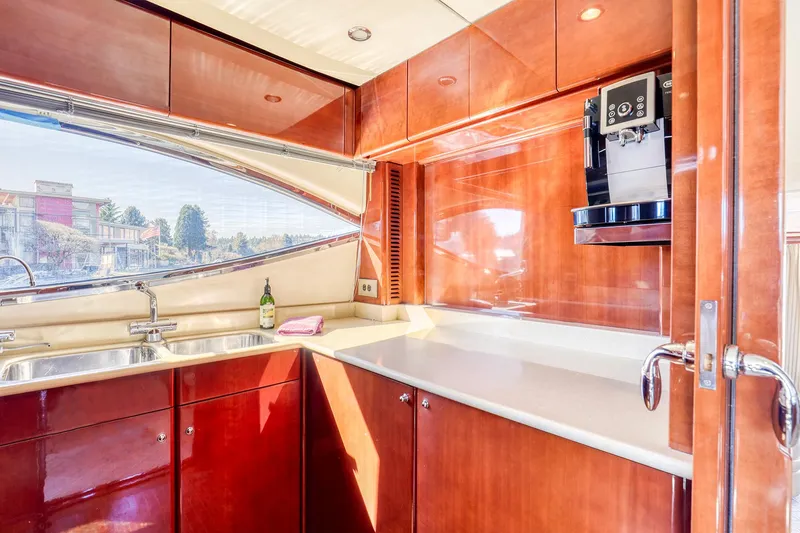 Slide: The Image of Luxurious kitchen interior of 2001 Viking Sport Cruisers Motoryacht with wood cabinetry and modern appliances. - 14